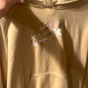 Two new Nike hoodies black one had never been worn and the beige has one time